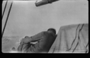 Image of Crewman on deck (sleeping?)